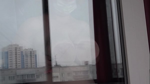 busty big tit babe fucks her pussy in front of window